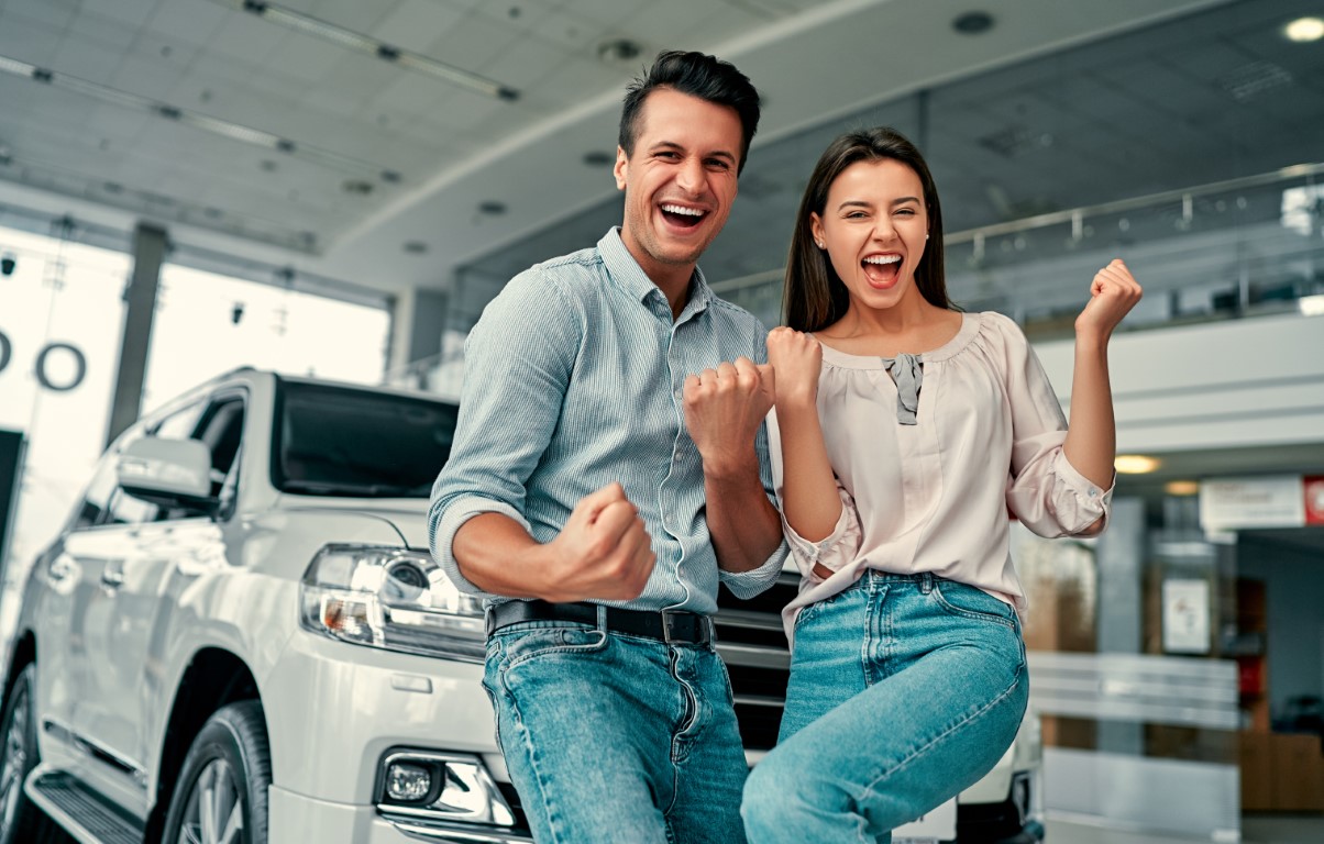 Father and daughter happily getting the keys to a new car