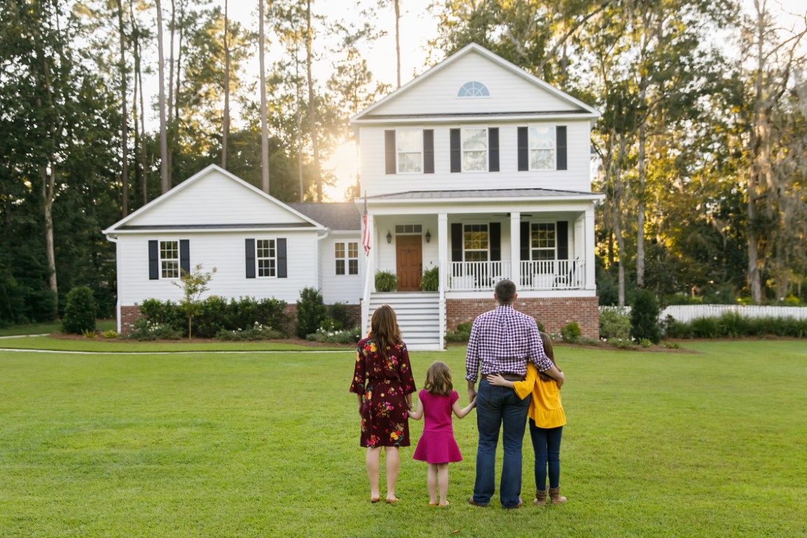 Family of four standing in front of their house in Woodstock, Georgia